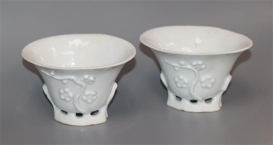 A pair of 18th century Chinese blanc de chine prunus libation cups